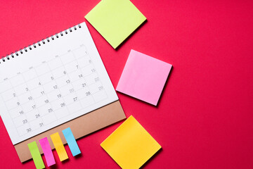 close up of calendar on the red table background, planning for business meeting or travel planning concept