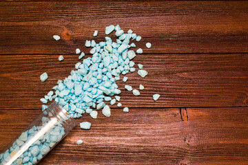 Decorative goove stones on a wooden background. Top view, place for text.