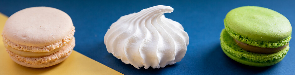 colorful unstable french macaroon cookies like background, dessert concept.Pop Art Color style with meringue and bakery goodies on bright colorful background. Candy shop, candy bar.banner for website