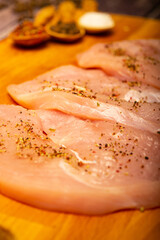 Meat steaks and various spices on a wooden Board. Close up.