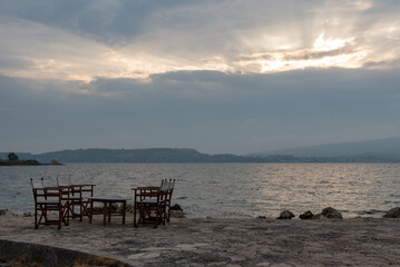 Small tables of a restaurant by the Greek sea