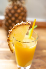 pineapple juice in a glass with a slice of pineapple fruit