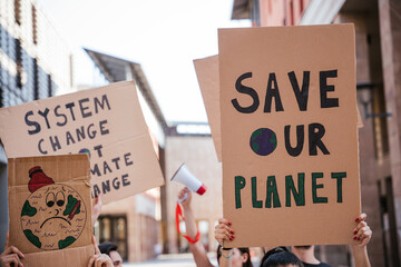 Group of young people at a demonstration for the environment - Young millennials protest at a procession to save the planet with slogans and drawn in the sign - Concept of manifestation - obrazy, fototapety, plakaty
