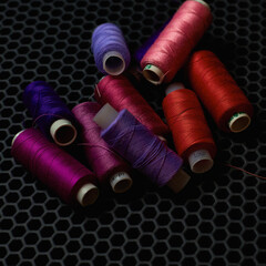 close-up multicolored threads on a dark background from above 
