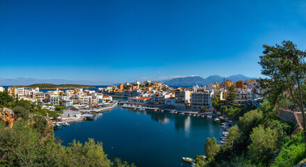 Fototapeta na wymiar Agios Nikolaos, Crete, Greece. Agios Nikolaos is town in the eastern part of the island Crete in bay of Mirabello. Voulismeni lake. HD Panoramic view.