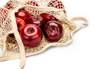 Red apples in cotton cloth bag