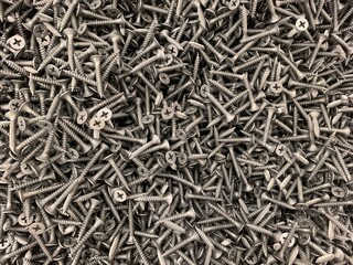 Concept of construction and repair. Black metal screws.