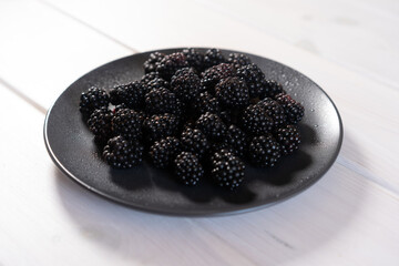 Fresh blackberry on a dark plate