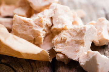 broken yeast cake on wax paper, weathered wood table background