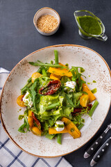 Pumpkin salad with cheese and dried tomatoes. Top view