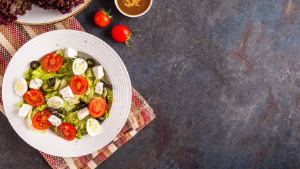 Salad with fresh vegetables, quail eggs and cheese. Top view, text space