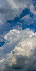 Vertical panorama of a sky fragment with Cumulus clouds