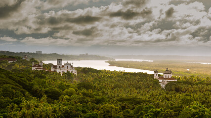 Aeriel view of tropical Landcsape in Goa, India with ancient catholic churches in the foreground