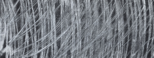 Scratched abstract background. Back to school. Old blackboard dirty with white chalk strokes.