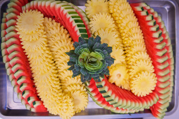 tropical fruit street vendor on the streets of Bangkok in Thailand, beautiful sliced different fruits, sale from a tray