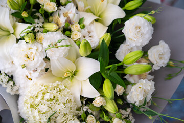 Obraz na płótnie Canvas white lilies and carnations. top view of bouquets of fresh flowers.