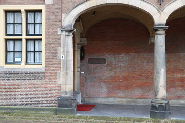 Entrance and sign of the Supreme court Raad van State at the government center Binnenhof in The Hague .