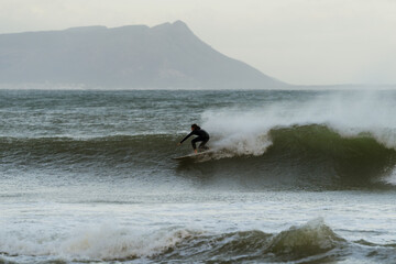 Surfer riding wave.