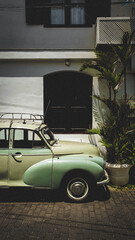 old car in front of a house
