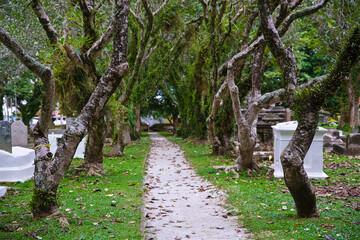 Fototapeta premium ancient catholic cemetery on the temple territory, old stone stupas, burial places of ashes of dead people, place of worship of ancestors