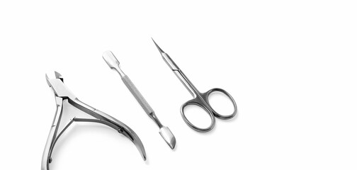 Close-up manicure and pedicure nail care tools set isolated on white background with selective focus and copy space. Cuticle pusher, cuticle trimmer and purpose scissor