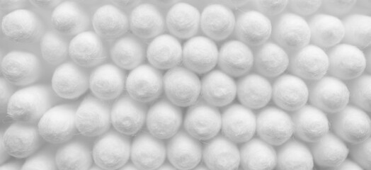 Cosmetic cotton buds texture with selective focus white background horizontal banner format. Abstract pure backdrop or wallpaper