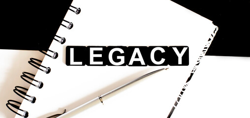 Business text LEGACY on notepad with pen