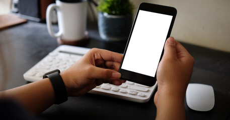 Mock up smartphone of hand holding black mobile phone with blank white screen.
