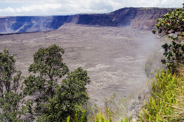 Panoramic view from edge of Kilauea Volcano crater and caldera with lava rock flow field and...
