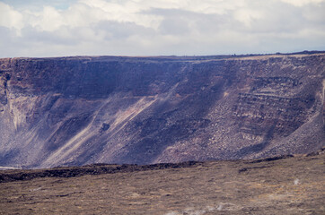 Panoramic view from edge of Kilauea Volcano crater and caldera with lava rock flow field and...
