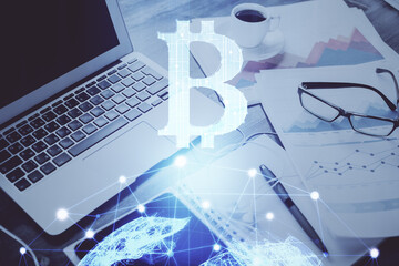 Double exposure of blockchain and crypto economy theme hologram and table with computer background....