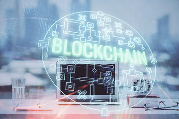 Double exposure of blockchain and crypto economy theme hologram and table with computer background....