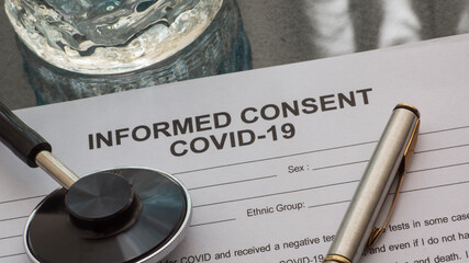 A informed consent form on the desk. informed consent  COVID-19 treatment.