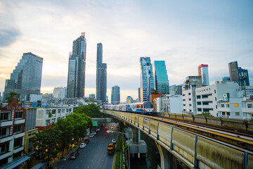 BTS sky train runs through the station. View of Bangkok skyline and skyscraper with BTS skytrain. 
