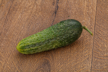 Green ripe fresh cucumber over background