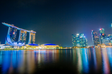 Fototapeta premium Beautiful architecture building skyscraper around marina bay in singapore city at night.
