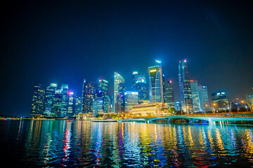 Beautiful architecture building skyscraper around marina bay in singapore city at night.