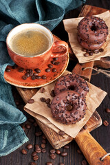 Cup of coffee and chocolate donuts
