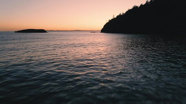 Drone Flying Over Driftwood and Crashing Wave at Rosario Beach After Sunset