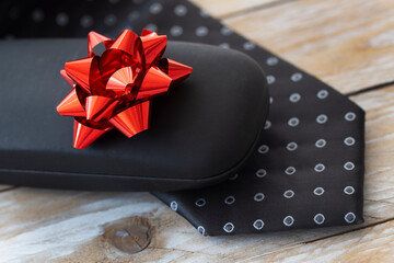 Father's Day Concept. Gift Box with Tie on wooden background. Copy space for text.