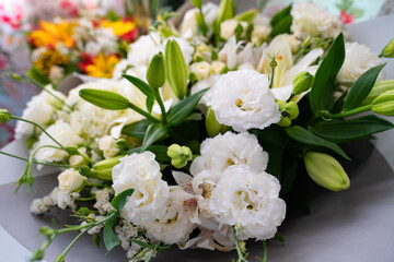 Obraz na płótnie Canvas white lilies and carnations. top view of bouquets of fresh flowers.