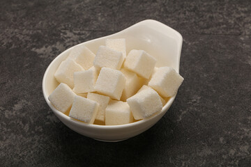 Refined white sugar cubs in the bowl
