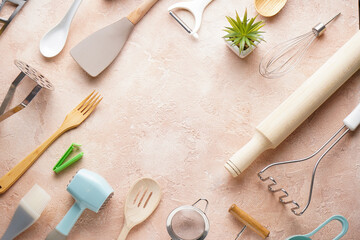 Various kitchen utensils on a beige background, top view, with place for text.