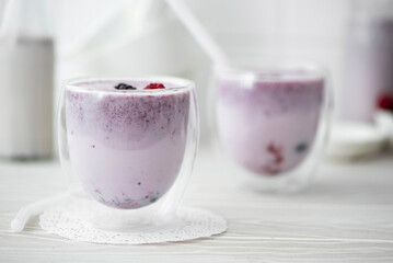 milkshake with frozen berries in glasses