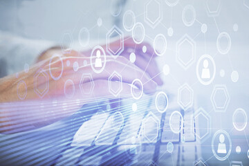 Obraz premium Social network theme hologram with businessman working on computer on background. Multi exposure.