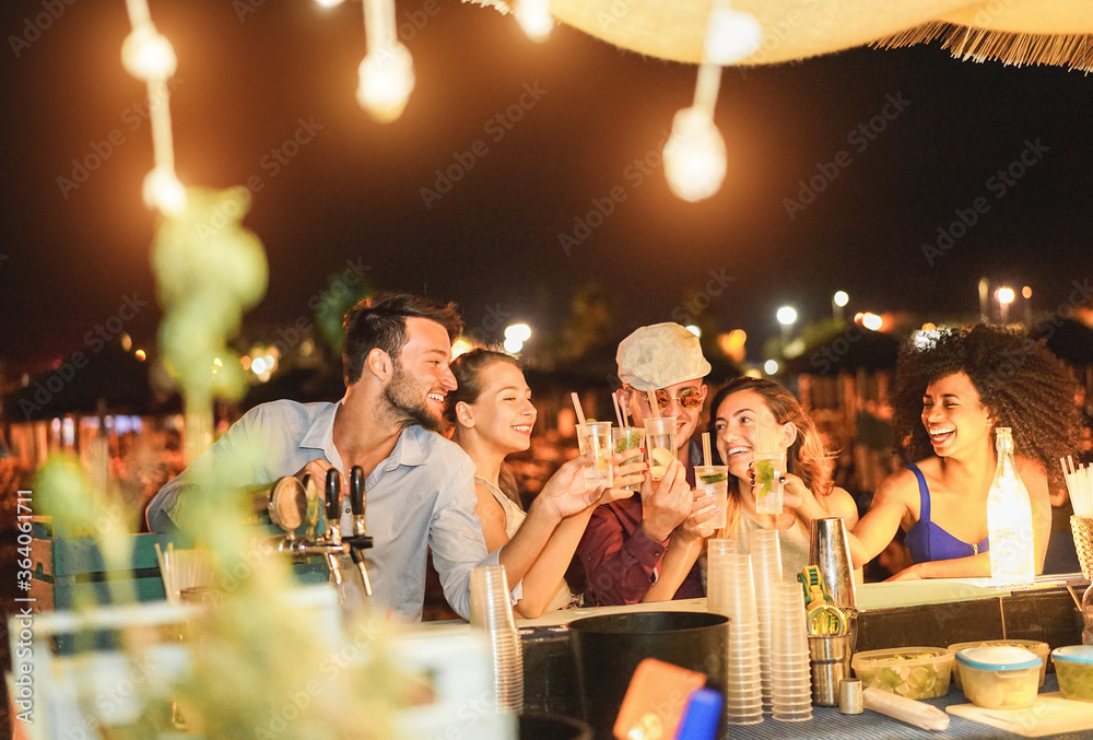 Wall mural happy friends cheering and drinking cocktails at beach party outdoor - young millennials people havi