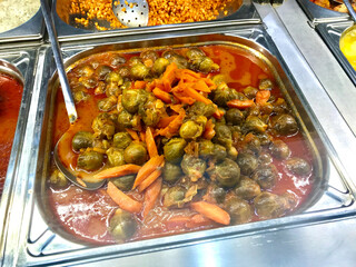 Local Turkish Restaurant Style Healthy Organic Vegan Vegetarian Hot Brussel Sprouts Food with Carrots and Tomato Paste.