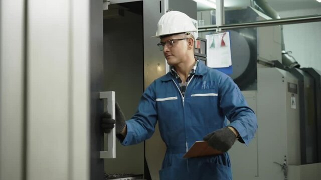 Construction or technician worker working in the factory with machine. Protective equipment such as hard hat and safety work clothes. Quality of production staff. Concept Team work