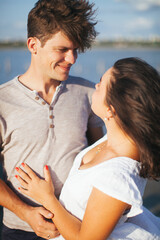 A couple in love on the beach. A man and a woman kiss. A couple in love walking on the beach. Date on the beach. Love.