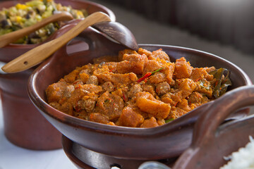 Javanese spicy stew of cattle skin crackers (krecek). typical side dish for gudeg. served in a traditional earthenware wok